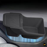 Black centre console storage box with sliding lid and textured base, designed for electric vehicle interiors.
