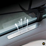 Silver metal air vent protection cover installed on car door panel with airflow illustration on grey interior trim