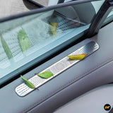Silver air vent protection cover installed on car door panel with autumn leaves resting on it