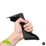 Hand gripping a flexible black silicone storage pouch for vehicle door compartments or hidden storage accessories.