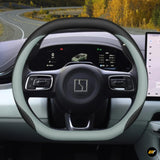 Premium leather steering wheel cover installed on electric vehicle steering wheel with digital dashboard display in background