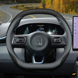 Black premium leather steering wheel cover fitted on electric vehicle steering wheel with digital dashboard display