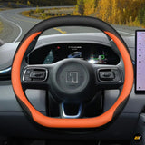 Premium black and orange leather steering wheel cover fitted on Zeekr electric vehicle steering wheel interior