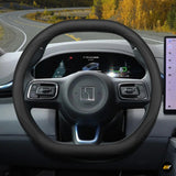 Premium black leather steering wheel cover on Zeekr electric vehicle with digital dashboard display visible.