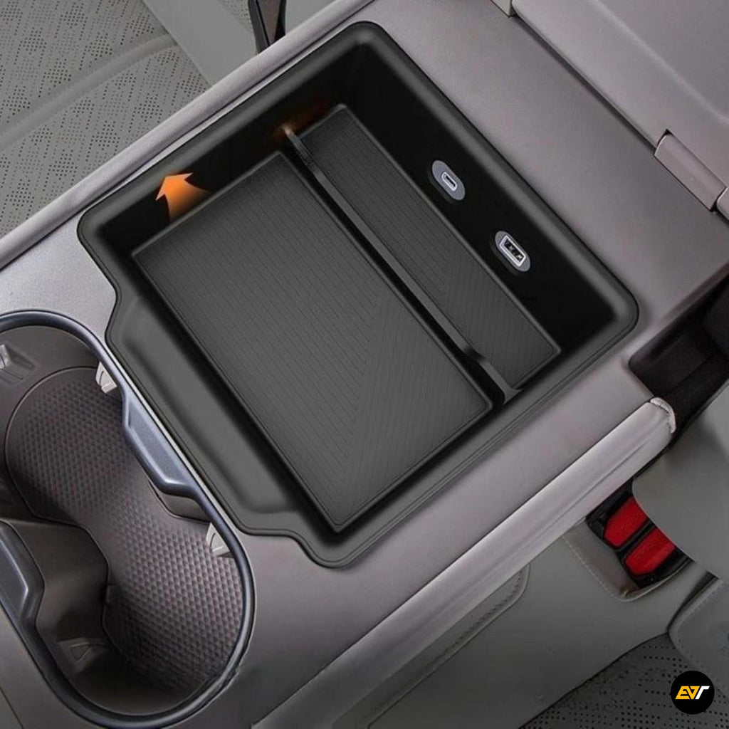 Black rear seat armrest storage box with USB ports and cup holder in an electric vehicle interior