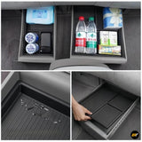 Underseat storage organisers for electric vehicle with separate compartments holding drinks, tissues, and personal items.