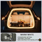 Rear view of open car trunk with warm white LED light strip installed around the opening, illuminating luggage and flowers inside